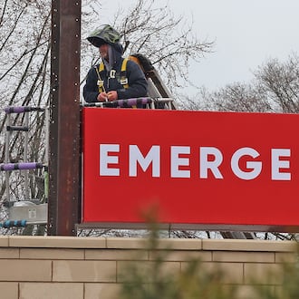 A man in a lift works on the new sign in front of the Kettering Health medical center at the intersection of Home Road and North Limestone Street Tuesday, March 22, 2022. The medical center is located in the old Kroger location. BILL LACKEY/STAFF