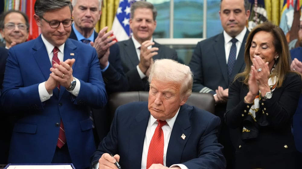 President Donald Trump signs the funding bill to reopen the government, in the Oval Office of the White House, Wednesday, Nov. 12, 2025, in Washington. (AP Photo/Jacquelyn Martin)