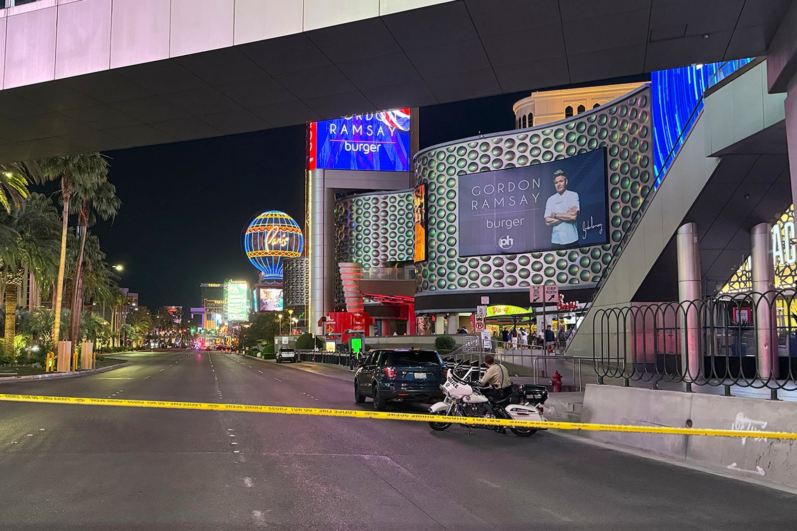 Las Vegas Metropolitan Police officers investigate the scene of a shooting on the Strip that left two dead Monday, June 9, 2025, in Las Vegas. (Madeline Carter/Las Vegas Review-Journal via AP)