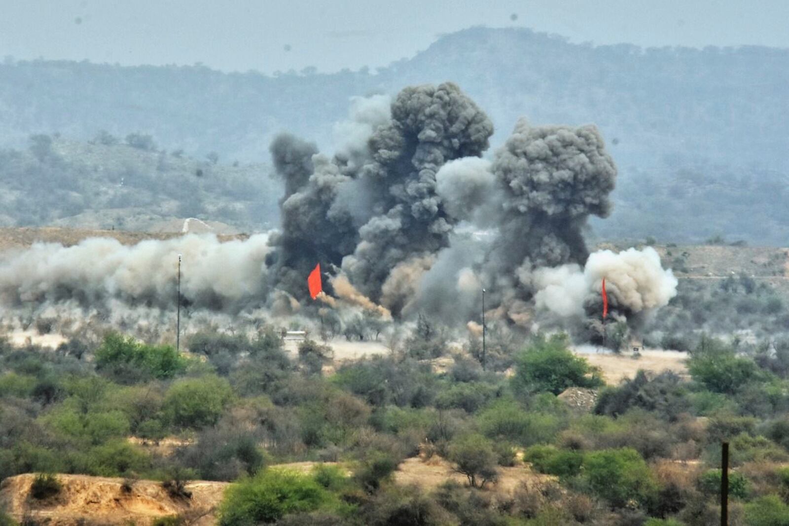 In this photo released by the Inter Services Public Relations, smoke erupts on mock target after Pakistani army artillery fire shell during a military exercises, in Tilla Field Firing Range, in the Jhelum district, Pakistan, Thursday, May 1, 2025. (Inter Services Public Relations via AP)