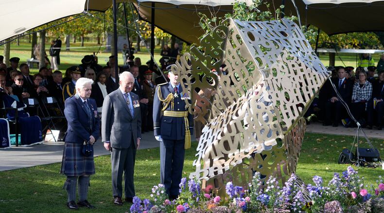 King Charles III stands during a visit to the National Memorial Arboretum in Alrewas, Staffordshire, for the dedication ceremony of the LGBT+ Armed Forces memorial, the UK's first national memorial commemorating LGBT+ people who have served and continue to serve in the military, Monday, Oct. 27, 2025. (Peter Byrne/PA via AP)