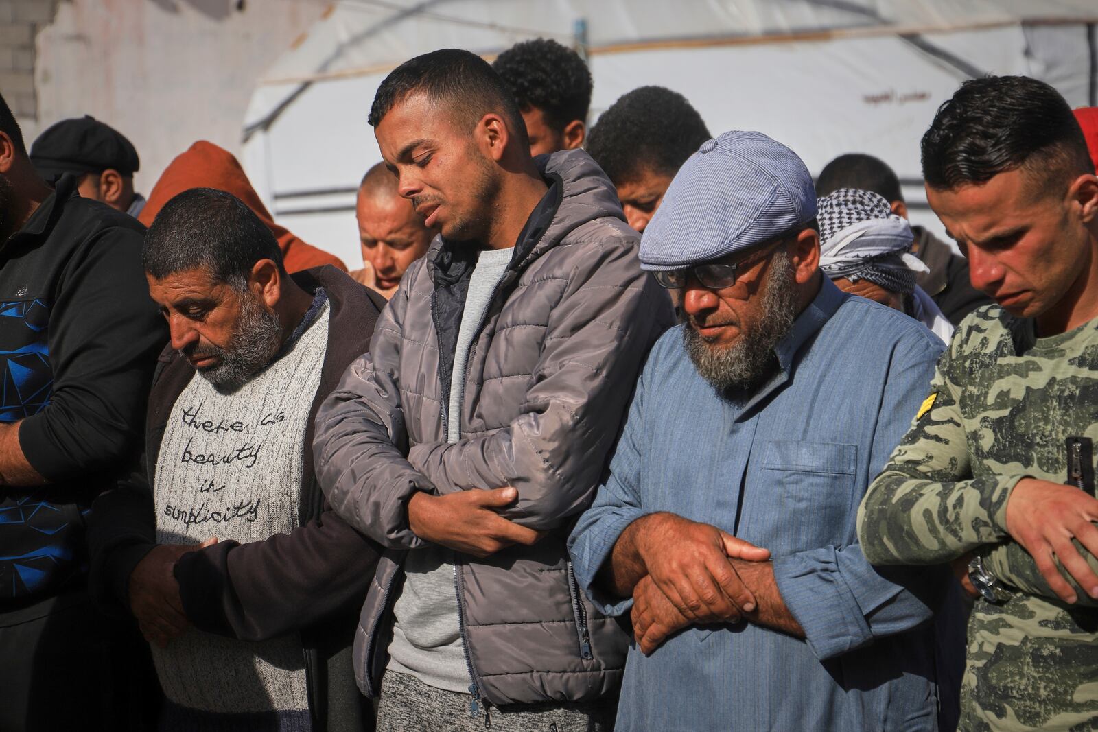 Nashat Seiam, second from right, joins relatives and friends in prayer over the body of his granddaughter Ahlam, who was just days away from her first birthday, during her funeral after she was killed by an overnight Israeli airstrike on her home in Khan Younis, southern Gaza Strip, on Wednesday, April 16, 2025,.(AP Photo/Mariam Dagga)
