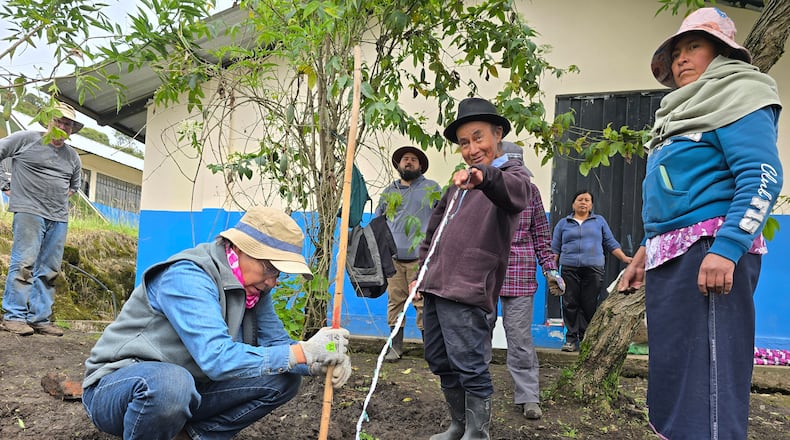 Master Gardener Volunteer Jo Roth working in the Quichinche community with parents of the children who attend the school to plant a garden.