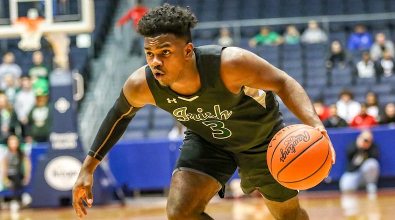 Catholic Central High School’s Jayden Borden drives to the hoop during the Irish’s 71-63 victory over New Miami in a D-IV district final game at the University of Dayton Arena on Friday, March 8. Catholic Central is 22-3 and will play St. Henry in a regional semifinal at 7 p.m. Tuesday at Kettering Fairmont’s Trent Arena. CONTRIBUTED PHOTO BY MICHAEL COOPER