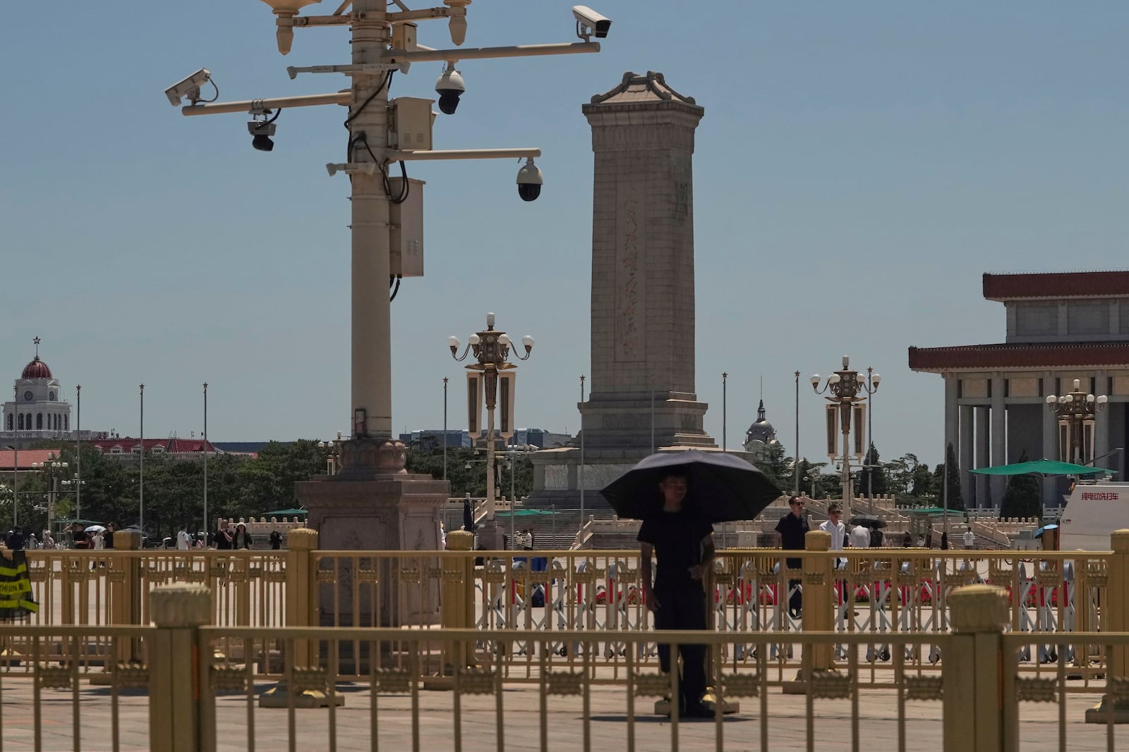 A plain clothes security person stands on duty near security cameras overlooking Tiananmen Square on the anniversary of China's bloody 1989 crackdown on pro-democracy protests in Beijing, Wednesday, June 4, 2025. (AP Photo/Ng Han Guan)