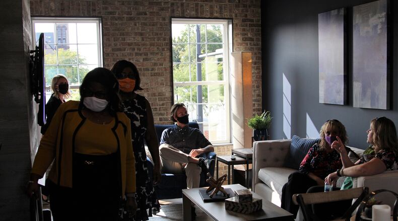City officials and members of Charles Simms Development tour a model home on Wednesday that is part of a larger project to bring 34 town homes to downtown Springfield. HASAN KARIM/STAFF.