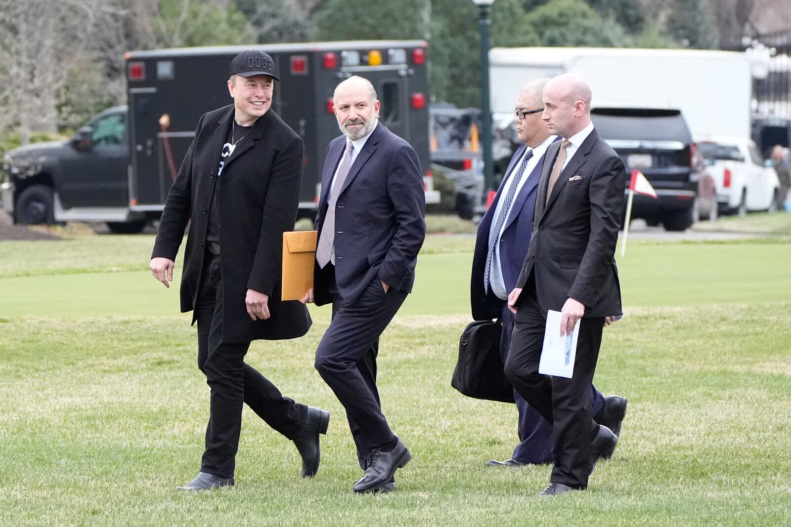 FILE - From left, Elon Musk, Commerce Secretary Howard Lutnick, Steven Cheung and Stephen Miller walk to board Marine One with President Donald Trump on the South Lawn of the White House, March 14, 2025, in Washington. (AP Photo/Alex Brandon, File)