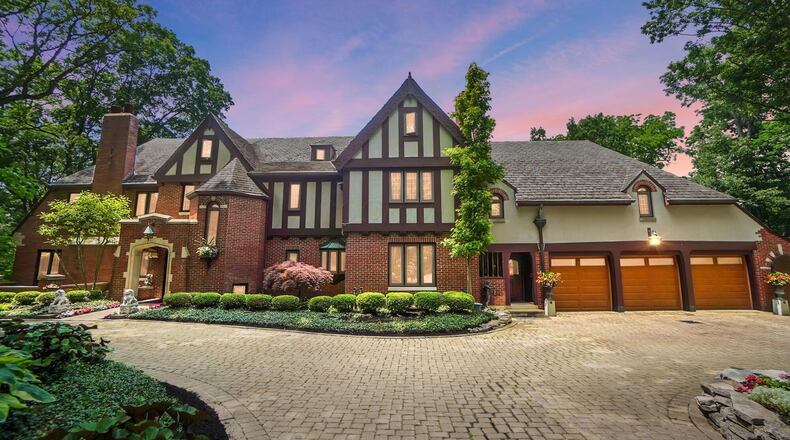 This tudor style two story has a six car garage and brick paver circular driveway. With nearly 7,000 square feet of living space, it sits on a five acre lot overlooking the Springfield Country Club golf course. CONTRIBUTED