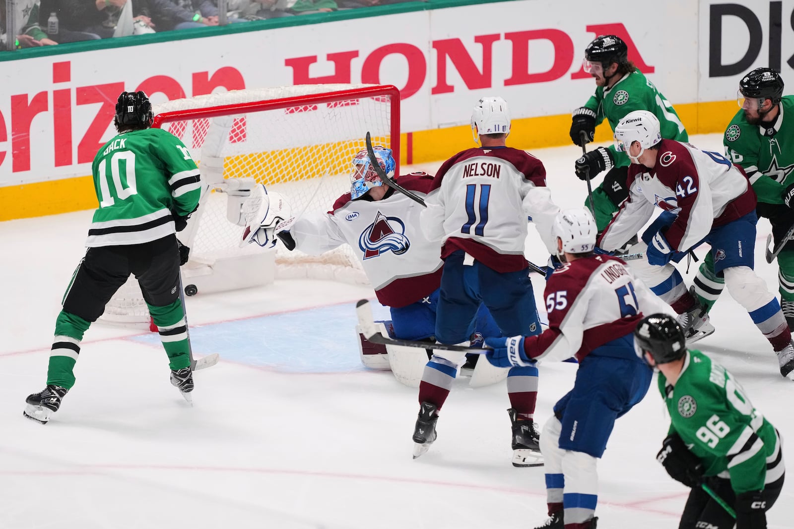 Dallas Stars' Oskar Back (10), Brock Nelson (11) and others loook on as a shot by Mikko Rantanen (96) gets past Colorado Avalanche's Mackenzie Blackwood (39) for a score in the third period in Game 7 of a first-round NHL hockey playoff series Saturday, May 3, 2025, in Dallas. (AP Photo/Julio Cortez)