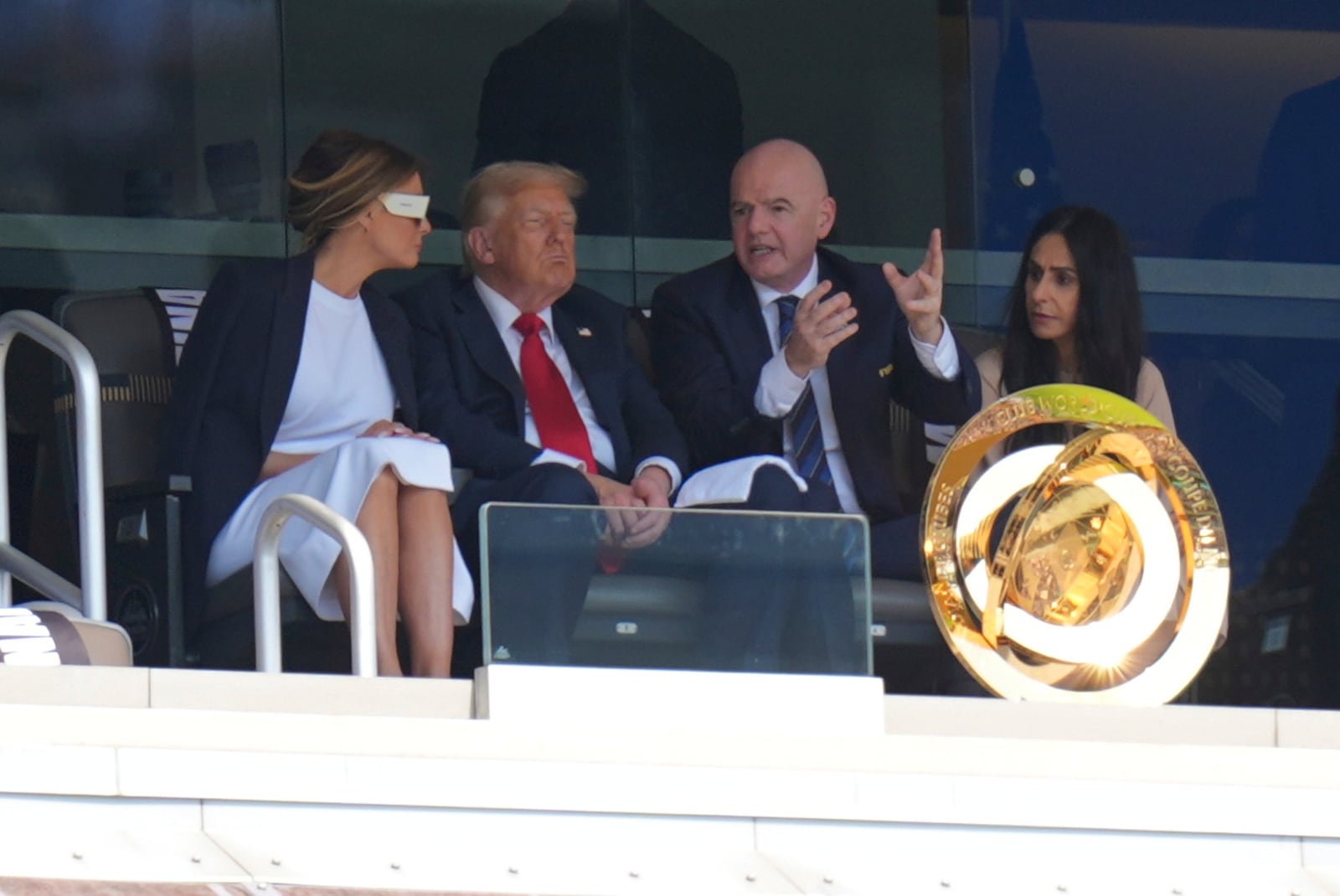FIFA President Gianni Infantino, right, speaks with President Donald Trump and first lady Melania Trump during the Club World Cup final soccer match between Chelsea and PSG in East Rutherford, N.J., Sunday, July 13, 2025. (AP Photo/Seth Wenig)