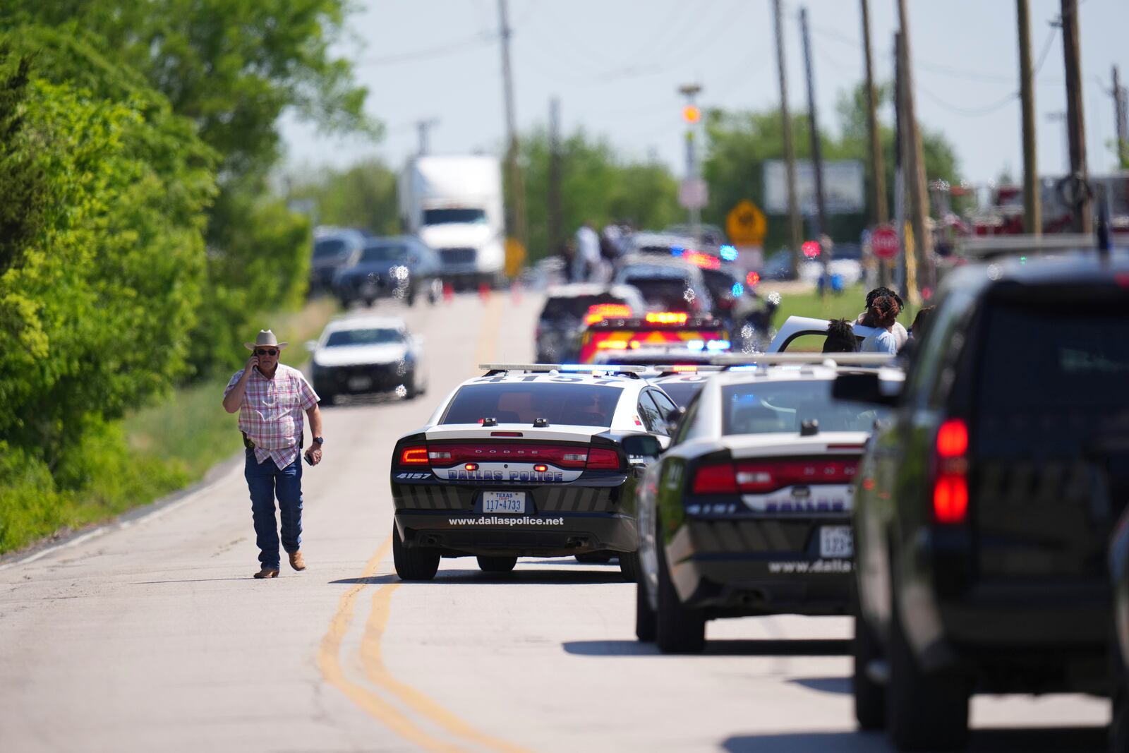 An undercover Texas Highway patrolman arrives to Wilmer-Hutchins High School, where police are responding to reports of a shooting at in Dallas, Tx., Tuesday, April 15, 2025. (AP Photo/Julio Cortez)