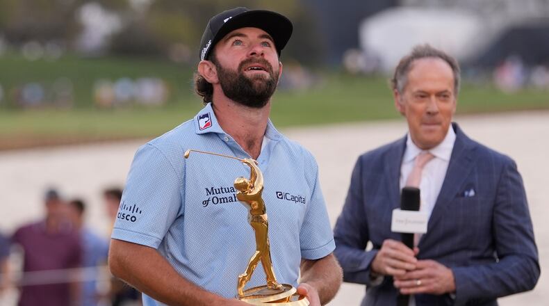 Cameron Young holds the The Players Championship Trophy after winning the final round of The Players Championship golf tournament, Sunday, March 15, 2026, in Ponte Vedra Beach, Fla. (AP Photo/Gerald Herbert)