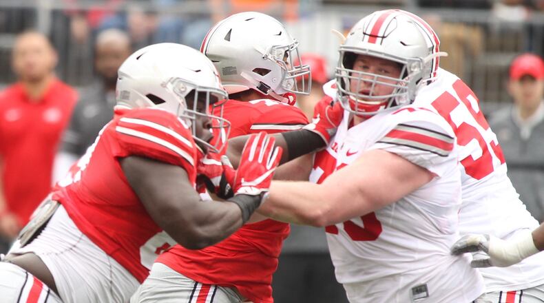 Ohio State's Robert Landers, left, rushes against Brady Taylor during the spring game on Saturday, April 14, 2018, at Ohio Stadium in Columbus. David Jablonski/Staff