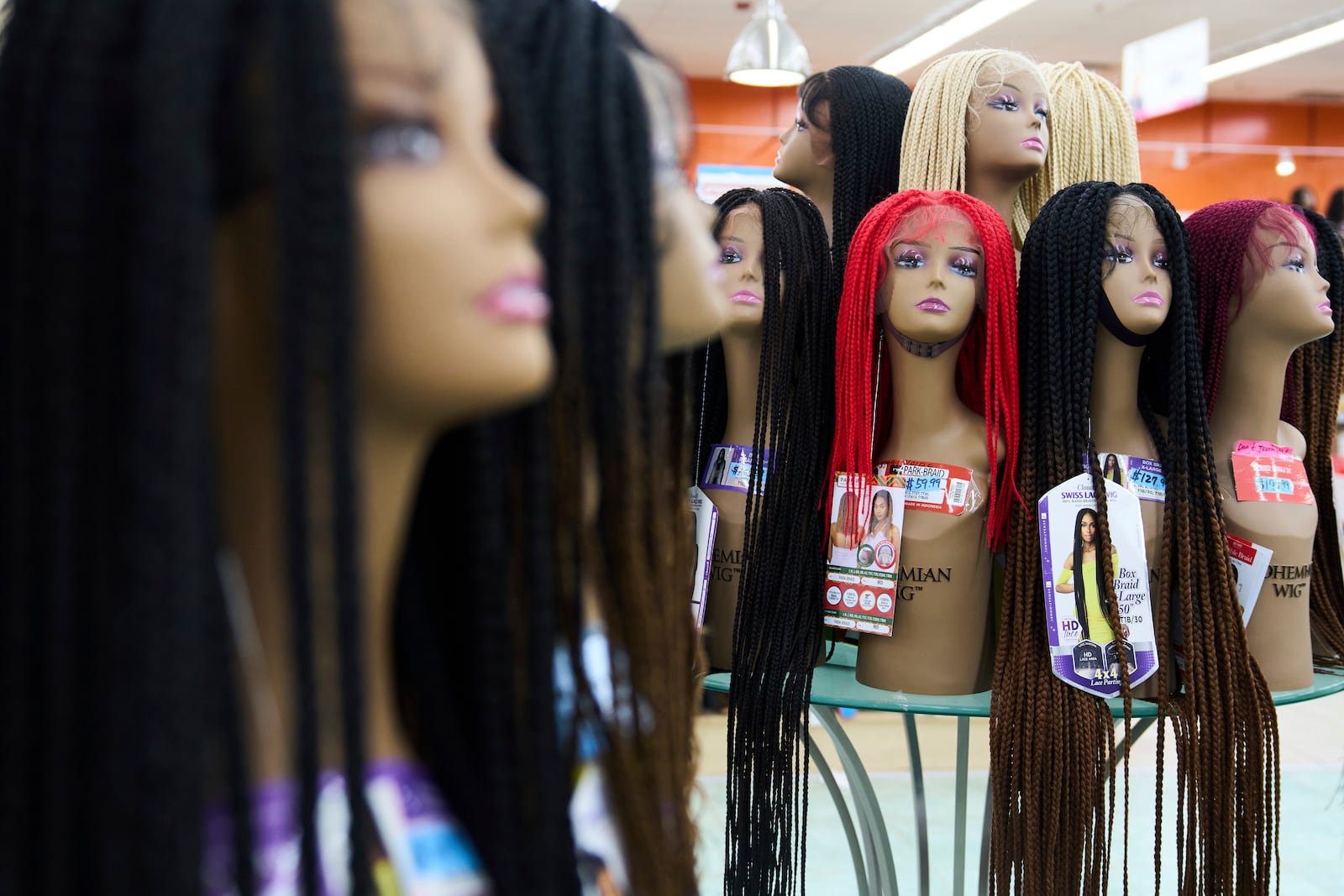 Braided wigs are seen on display at Chapel Beauty, a beauty supply store in Decatur, Ga., Monday, May 5, 2025. (AP Photo/Stephanie Scarbrough)
