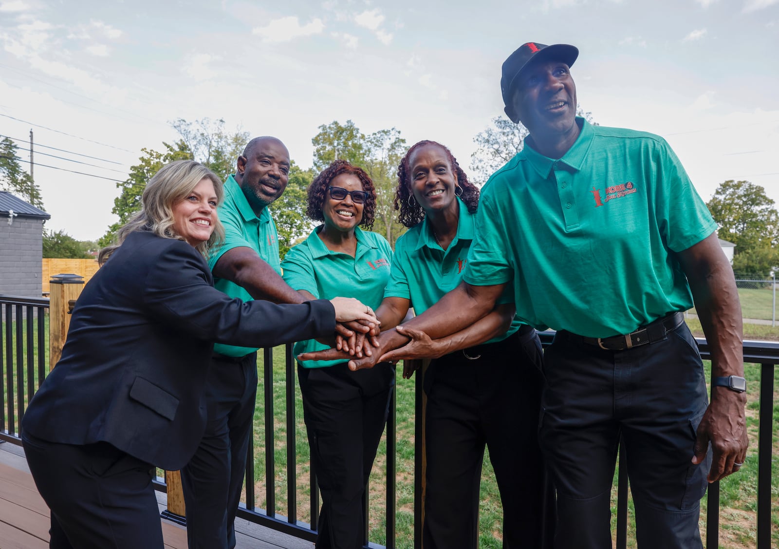 Left to right, Sabrina Tackett, vice president of NCF Savings Bank, poses for a portrait with Kore 4 co-owners Vernon and Sunna Bass, left, and Nettie Carter-Smith and Jamel Smith on Tuesday, September 23, 2025, at Kore 4's completed property and venue that's been renovated into a commercial kitchen and community event space in Springfield. JOSEPH COOKE/STAFF


