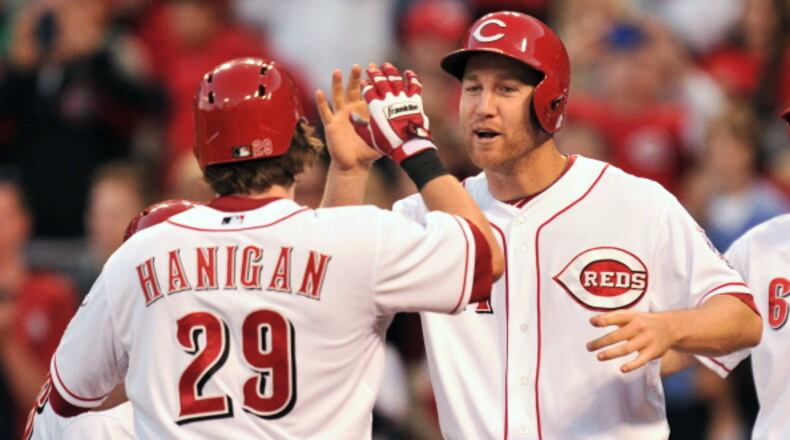 CINCINNATI, OH - MAY 24: Todd Frazier #21 of the Cincinnati Reds congratulates teammate Ryan Hanigan #29 after Hanigan's two-out, three-run home run in the fifth inning gave the Reds a lead over the Chicago Cubs at Great American Ball Park on May 24, 2013 in Cincinnati, Ohio. Cincinnati defeated Chicago 7-4. (Photo by Jamie Sabau/Getty Images)