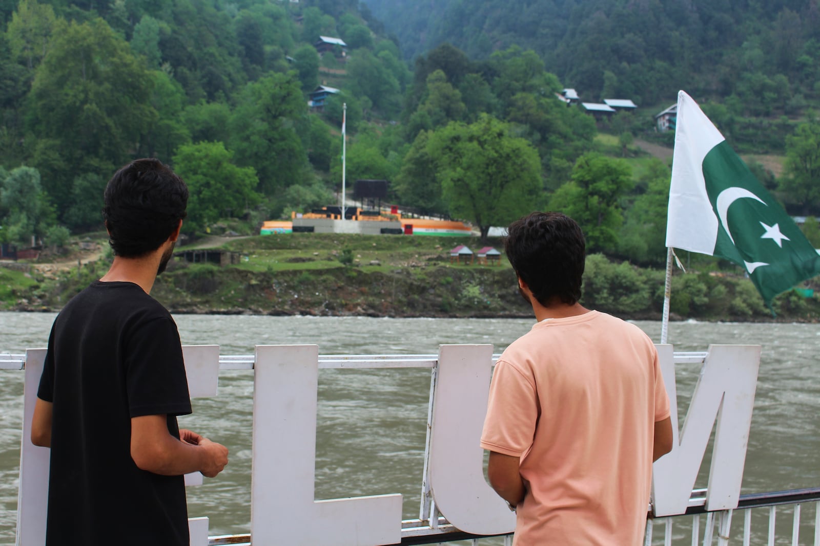 Local residents look at the Indian side of Kashmir from a tourists point in Karen, in the Neelum Valley near on the Line of Control, the de facto border that divides the disputed region of Kashmir, some 93 kilometres (58 miles) from Muzaffarabad, the capital of Pakistan controlled Kashmir, Thursday, May 1, 2025. (AP Photo/Ishfaq Hussain)