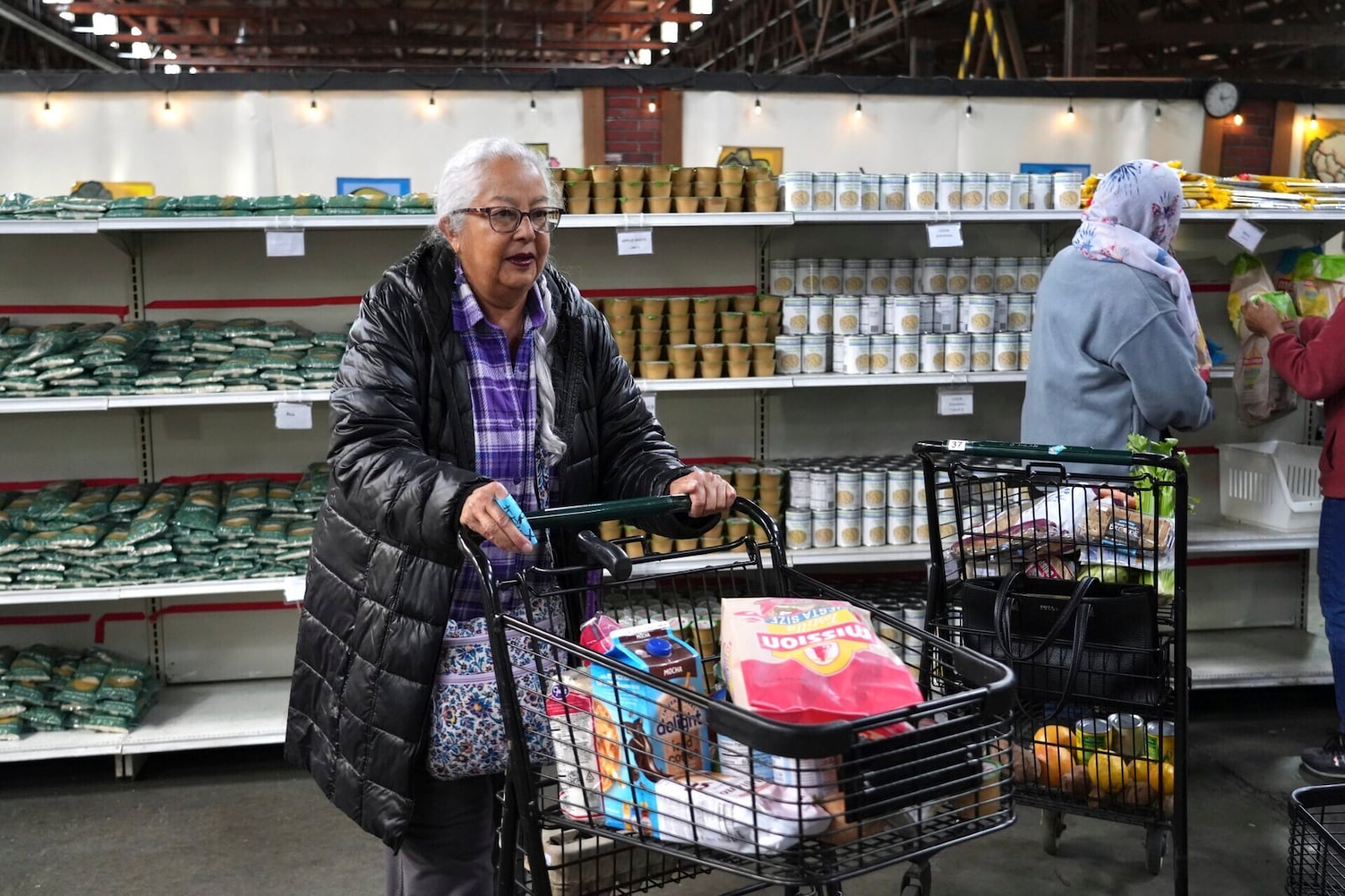 Alameda resident Beatriz Cortez picks up groceries at the Alameda Food Bank on Friday, April 25, 2025. (AP Photo/Terry Chea)