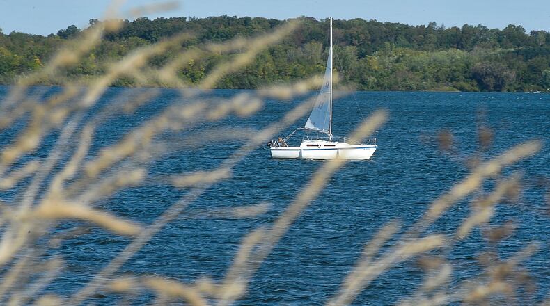 A sailboat owner takes advantage of a breezy day to sail around C.J. Brown Reservoir. Staff photo by Bill Lackey