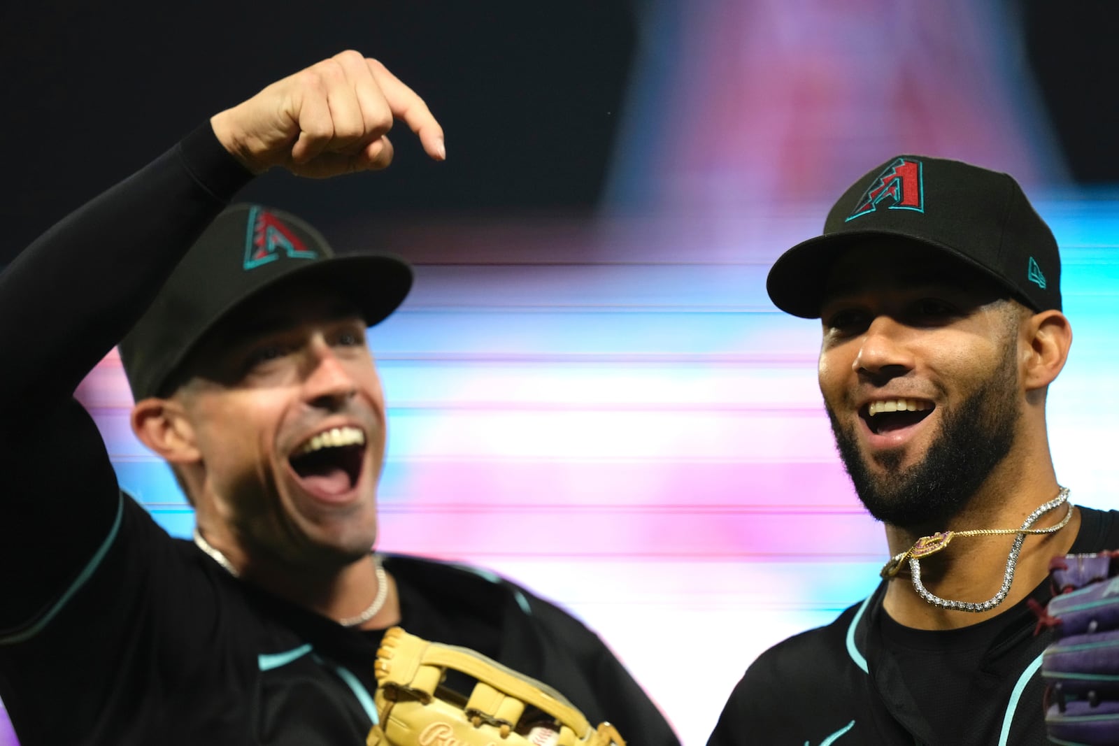 Arizona Diamondbacks' Lourdes Gurriel Jr., right, is congratulated by Randal Grichuk after making a catch on a ball hit by Los Angeles Angels' Jo Adell during the eighth inning of a baseball game Friday, July 11, 2025 in Anaheim, Calif. (AP Photo/Mark J. Terrill)