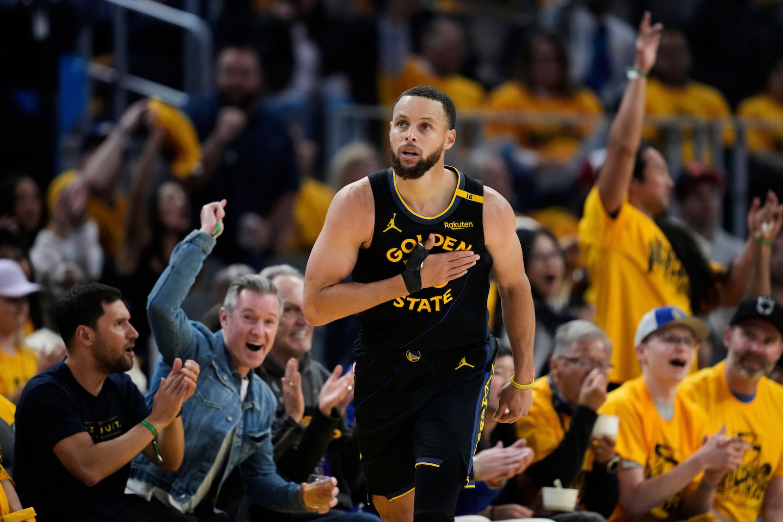 Golden State Warriors guard Stephen Curry reacts after making a 3-point basket during the second half of Game 6 of an NBA basketball first-round playoff series against the Houston Rockets, Friday, May 2, 2025, in San Francisco. (AP Photo/Godofredo A. Vásquez)