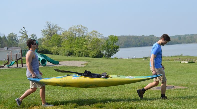 Jackson Gray (left) and Quinton Couch take a kayak to Hueston Woods Acton Lake for some practice before their 981-mile Race the River adventure. CONTRIBUTED/BOB RATTERMAN