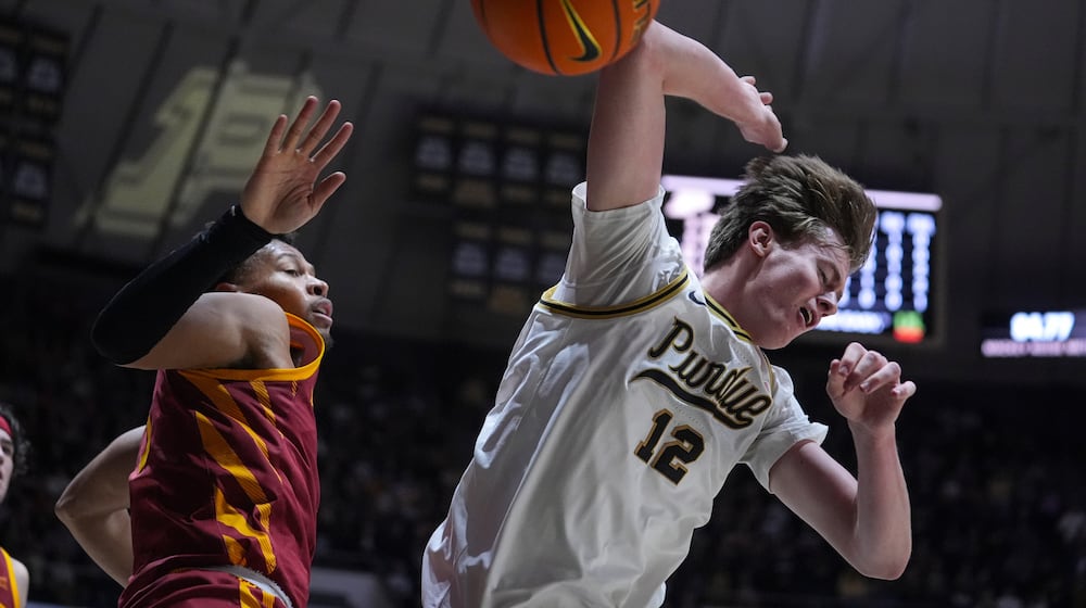 Purdue center Daniel Jacobsen (12) looses the ball after being fouled by Iowa State forward Joshua Jefferson (5) during the second half of an NCAA college basketball game in West Lafayette, Ind., Saturday, Dec. 6, 2025. (AP Photo/Michael Conroy)