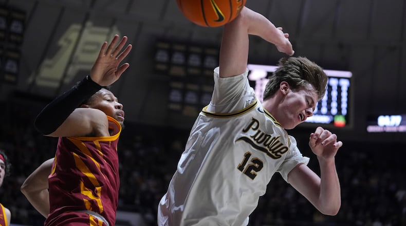 Purdue center Daniel Jacobsen (12) looses the ball after being fouled by Iowa State forward Joshua Jefferson (5) during the second half of an NCAA college basketball game in West Lafayette, Ind., Saturday, Dec. 6, 2025. (AP Photo/Michael Conroy)