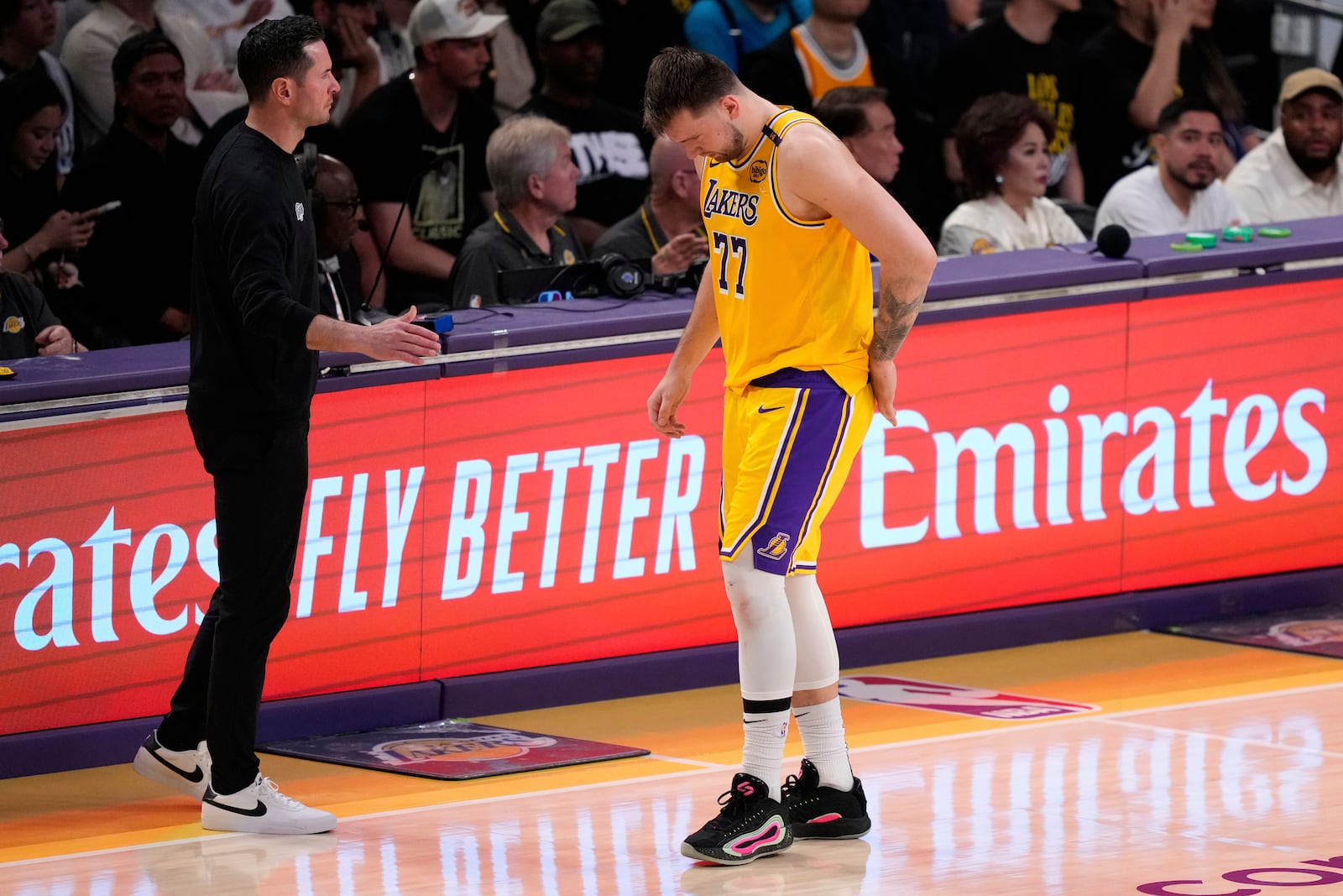 Los Angeles Lakers guard Luka Doncic (77) walks off the court after an injury during the first half in Game 5 of an NBA basketball first-round playoff series against the Minnesota Timberwolves, Wednesday, April 30, 2025, in Los Angeles. (AP Photo/Mark J. Terrill)