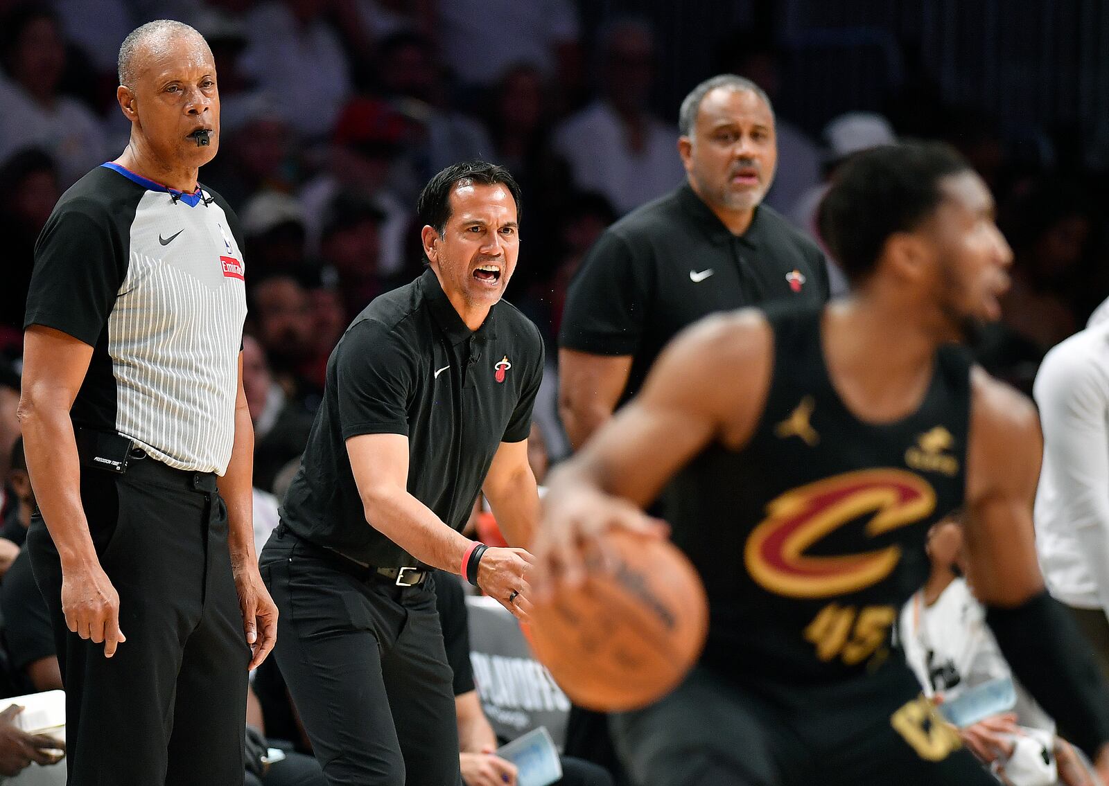 Miami Heat coach Erik Spoelstra screams instructions to his players as Cleveland Cavaliers guard Donovan Mitchell (45) dribbles during the first half in Game 3 of an NBA basketball first-round playoff series, Saturday, April 26, 2025, in Miami. (AP Photo/Michael Laughlin)