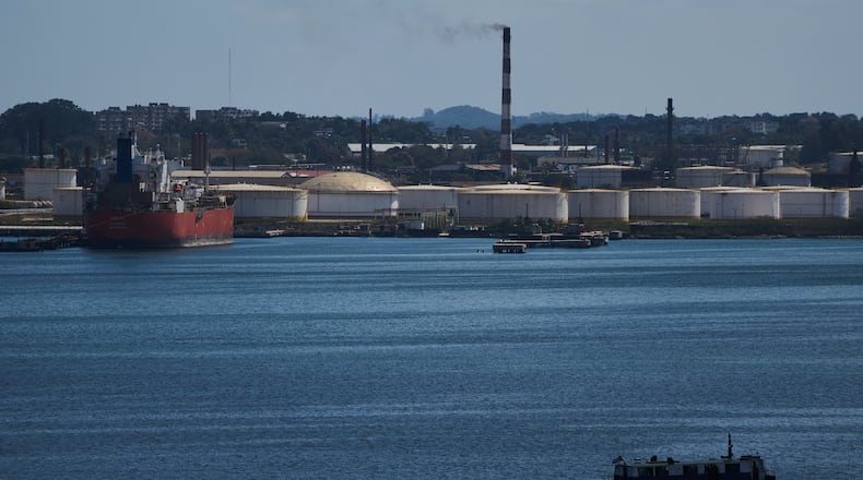 A ferry crosses Havana Bay past the Nico Lopez oil refinery where a Cuban tanker is anchored in Havana, Cuba, Thursday, Feb. 26, 2026. (AP Photo/Ramon Espinosa)