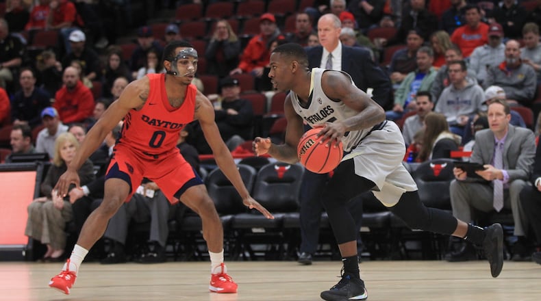 Colorado’s McKinley Wright dribbles against Dayton’s Rodney Chatman on Saturday, Dec. 21, 2019, at the United Center in Chicago.