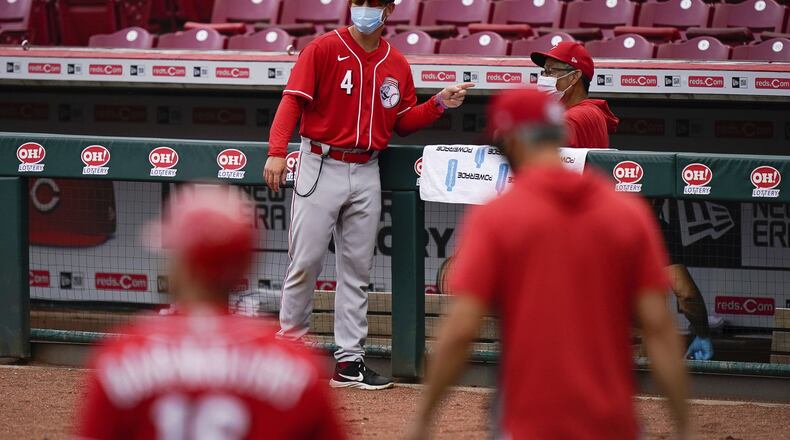 Cincinnati Reds center fielder Shogo Akiyama (4) speaks with a member of the staff during team baseball practice at Great American Ballpark in Cincinnati, Friday, July 10, 2020. (AP Photo/Bryan Woolston)