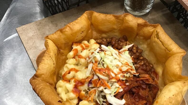 Smokehouse Bowl at Great American Ball Park: Imagine a large, bowl-shaped tortilla shell packed with pulled pork, coleslaw, and mac and cheese, topped with Montgomery Inn BBQ sauce. CONTRIBUTED