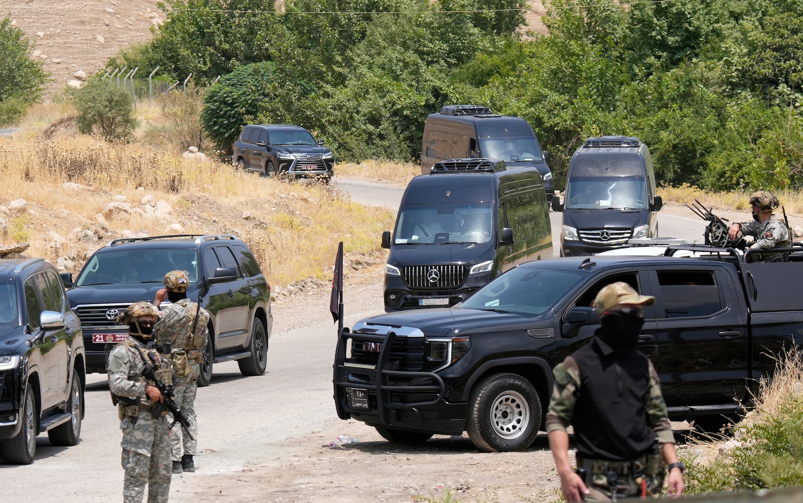 Forces of the regional Kurdish administration secure the area of the Jasana Cave ahead of a symbolic disarmament ceremony by the separatist PKK group as part of the peace process with Turkey, in Sulaymaniyah governorate, Iraq, Friday, July 11, 2025. (AP Photo/Hadi Mizban)