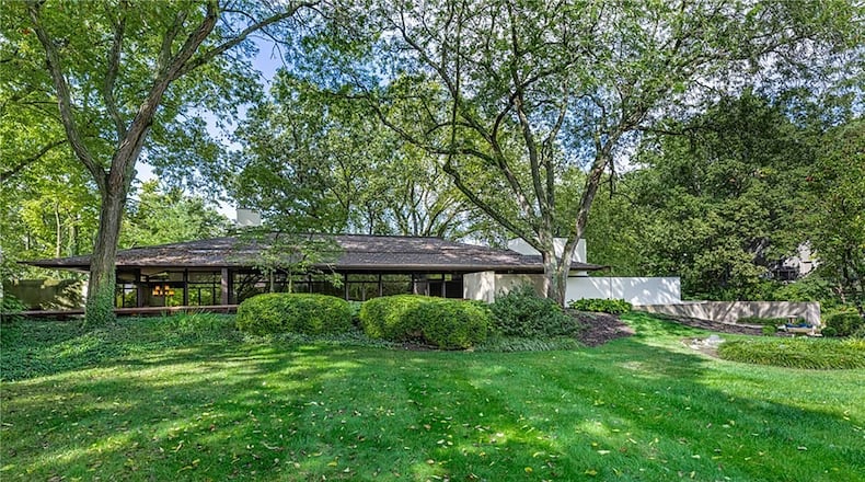 Nestled on a serene, wooded lot, this architecturally striking home takes inspiration from the historic designs of Frank Lloyd Wright blending natural materials, large windows and expansive glass walls. CONTRIBUTED