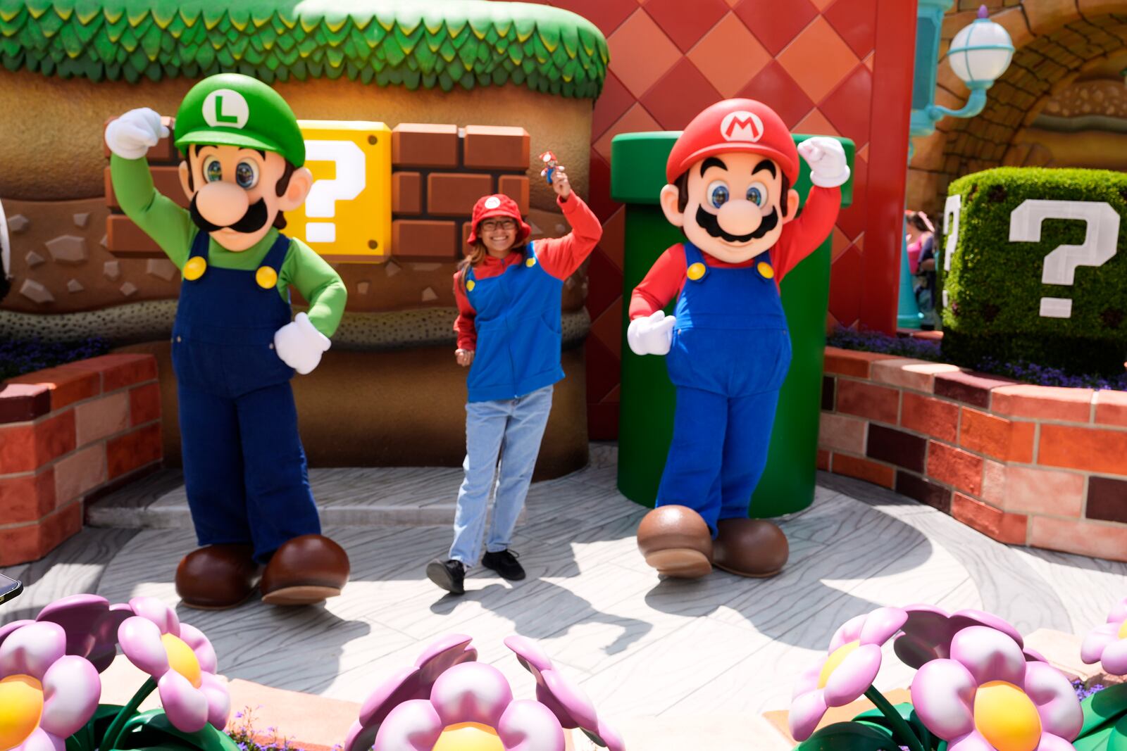 A guest interacts with characters in Super Nintendo World at Epic Universe at Universal Resort Orlando Thursday, April 10, 2025, in Orlando, Fla. (AP Photo/John Raoux)