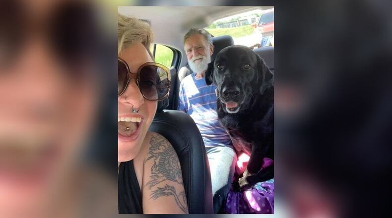 Roger Frost and his dog Jake in the backseat of a car.
