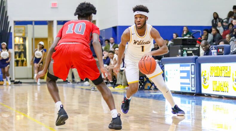 Springfield High School’s Larry Stephens drives to the hoop against Princeton’s Greg Johnson during their game in Springfield on Tuesday night. The Wildcats won 59-48. CONTRIBUTED PHOTO BY MICHAEL COOPER
