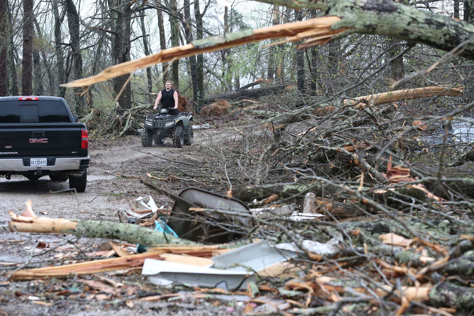 A resident along Tippah County Rd. 122 in the Three Forks Community near Walnut, Miss., makes his way down his driveway Thursday, April 3, 205, to inspect the tornado damage in the daylight hours. (Thomas Wells /The Northeast Mississippi Daily Journal via AP)