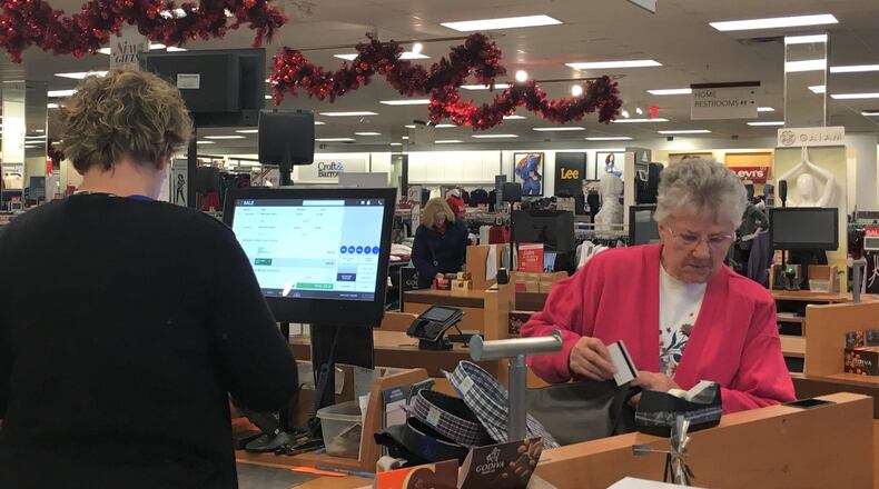 Holiday shoppers are already hitting store as the “Super Bowl” retail week approaches. Ruth Hildebrecht checks out at the Centerville Kohl’s. STAFF PHOTO / HOLLY SHIVELY