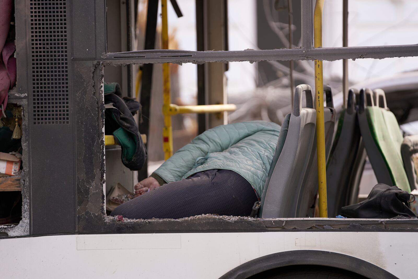 The body of the killed resident lies in a bus following the Russia's missile attack that killed at least 21 civilians in Sumy, Ukraine, Sunday, April 13, 2025. (AP Photo)