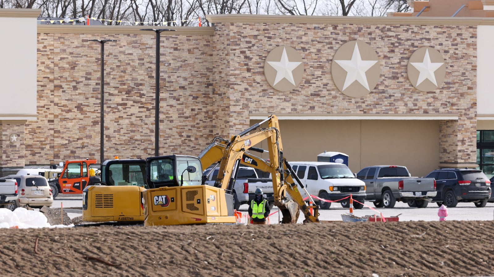 A construction worker watches as another operates an excavator on Friday, Jan. 23 at Buc-ee's on Ohio 235 in Huber Heights near the Interstate 70 interchange. Construction is continuing on the megastore, which Huber Heights Mayor Jeff Gore announced earlier this week would open on April 6. BRYANT BILLING/STAFF
