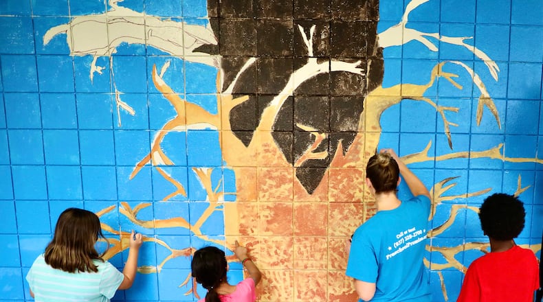 Perrin Woods Elementary Junior Lighthouse Team painting the school's new tree mural in the school's main hallway a few months ago. This mural is be part of the new district-wide initiative 'Leader in Me.' When a staff member or student at Perrin Woods memorizes the '7 Habits' from Leader in Me, they will put their handprints on the new mural. Contributed