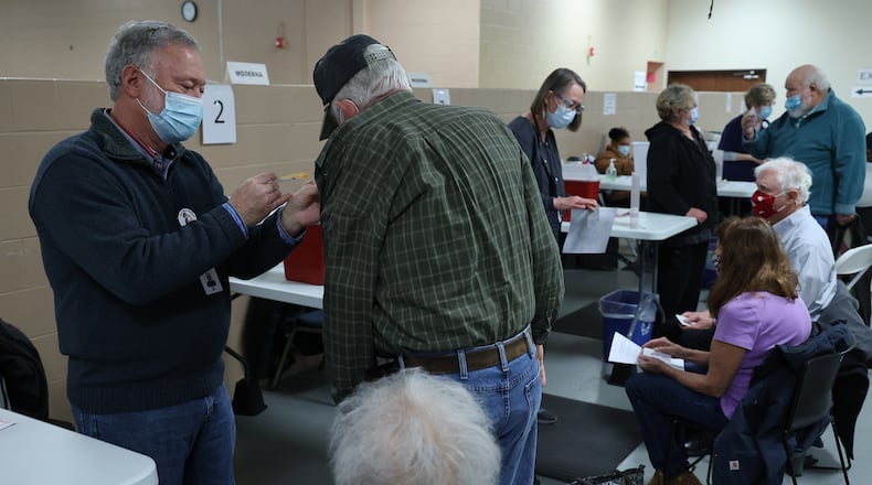 People get their COVID booster shot at the Clark County Combined Health District's Vaccine Center in January. BILL LACKEY/STAFF