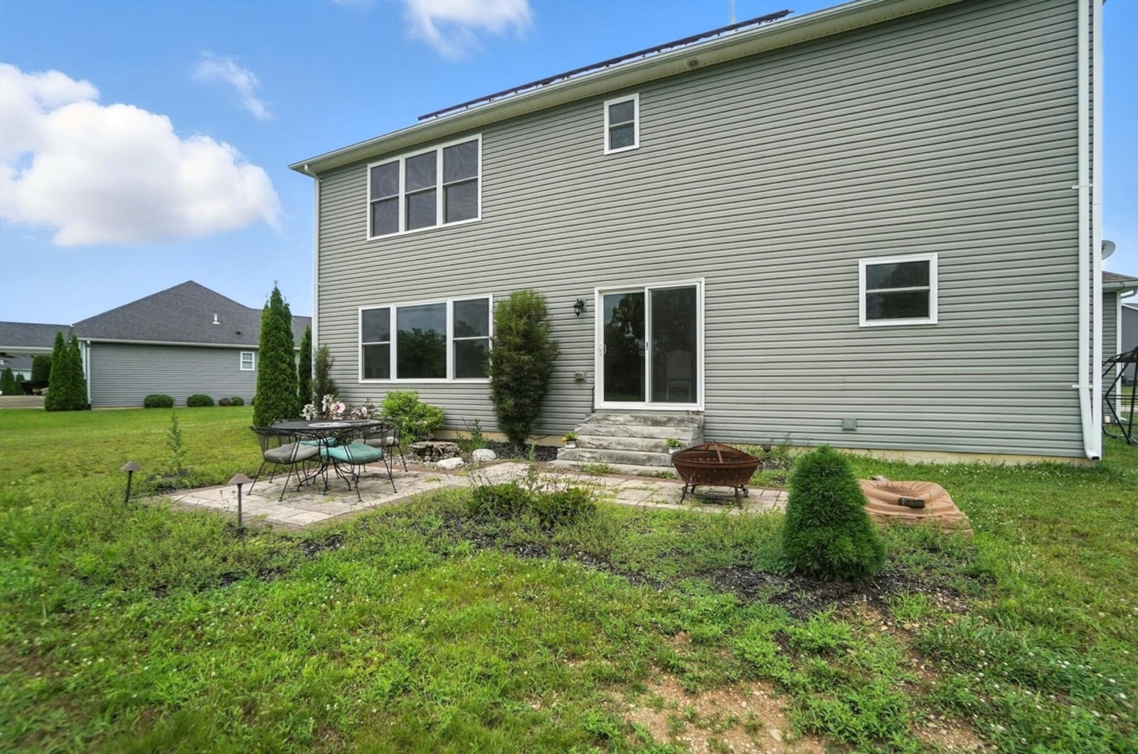 The rear of the home features two custom paver patios and woods at the back of the lot. CONTRIBUTED