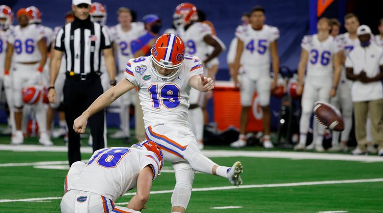 Florida punter Jacob Finn (18) holds as Evan McPherson (19) kicks a field goal against Oklahoma during the first half of the Cotton Bowl NCAA college football game in Arlington, Texas, Wednesday, Dec. 30, 2020. (AP Photo/Michael Ainsworth)