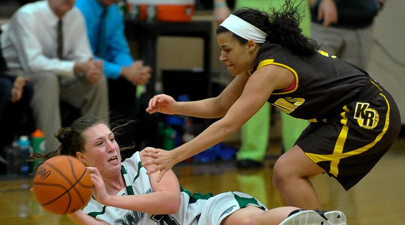 Greenville's Megan Galloway tries to get rid of the ball after recovering it under pressure from Kenton Ridge's Aianna Wilson during Wednesday's tournament game at Tecumseh. Bill Lackey/Staff
