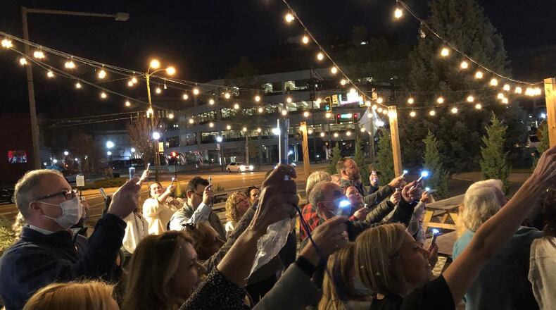 Attendees of the Thursday's "Shine a Light on Lung Cancer" awareness event at COHatch symbolically shine lights to honor those in the fight or who have fought against lung cancer. Photo by Brett Turner
