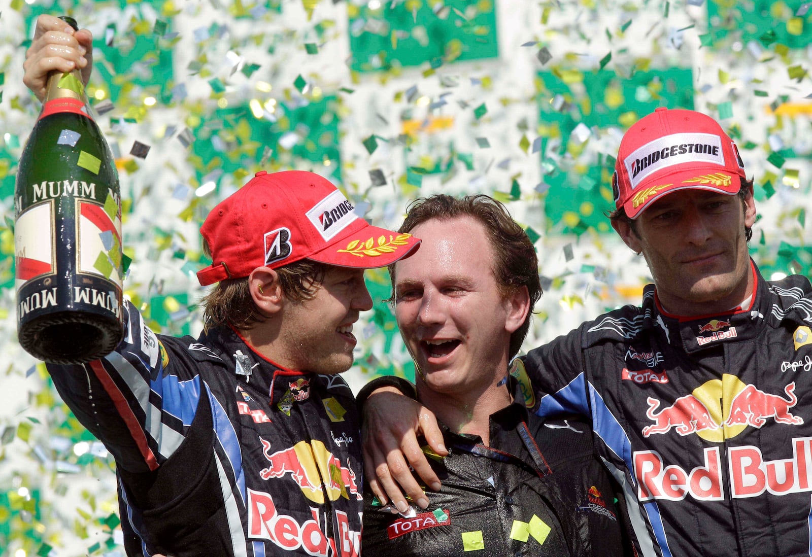 FILE -First place Red Bull driver Sebastian Vettel, of Germany, left, Red Bull team principal Christian Horner, center, and second place Red Bull driver Mark Webber, of Australia, celebrate on the podium after winning Brazil's Formula One Grand Prix at the Interlagos race track in Sao Paulo, Brazil, Nov. 7, 2010. (AP Photo/Luca Bruno), File)